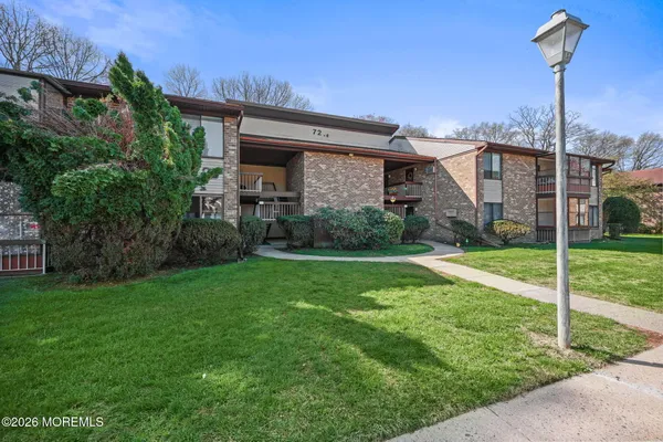 a view of a house with a backyard and a garden