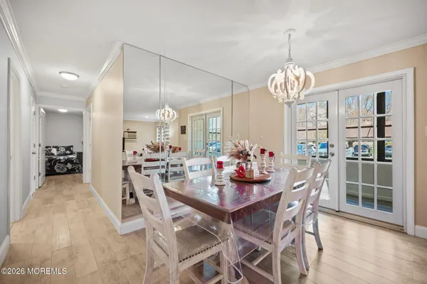 a view of a dining room with furniture wooden floor and chandelier