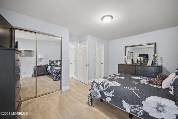 a bedroom with a large bed and a mirror