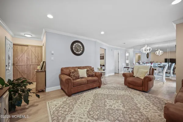 a living room with furniture a clock and a window