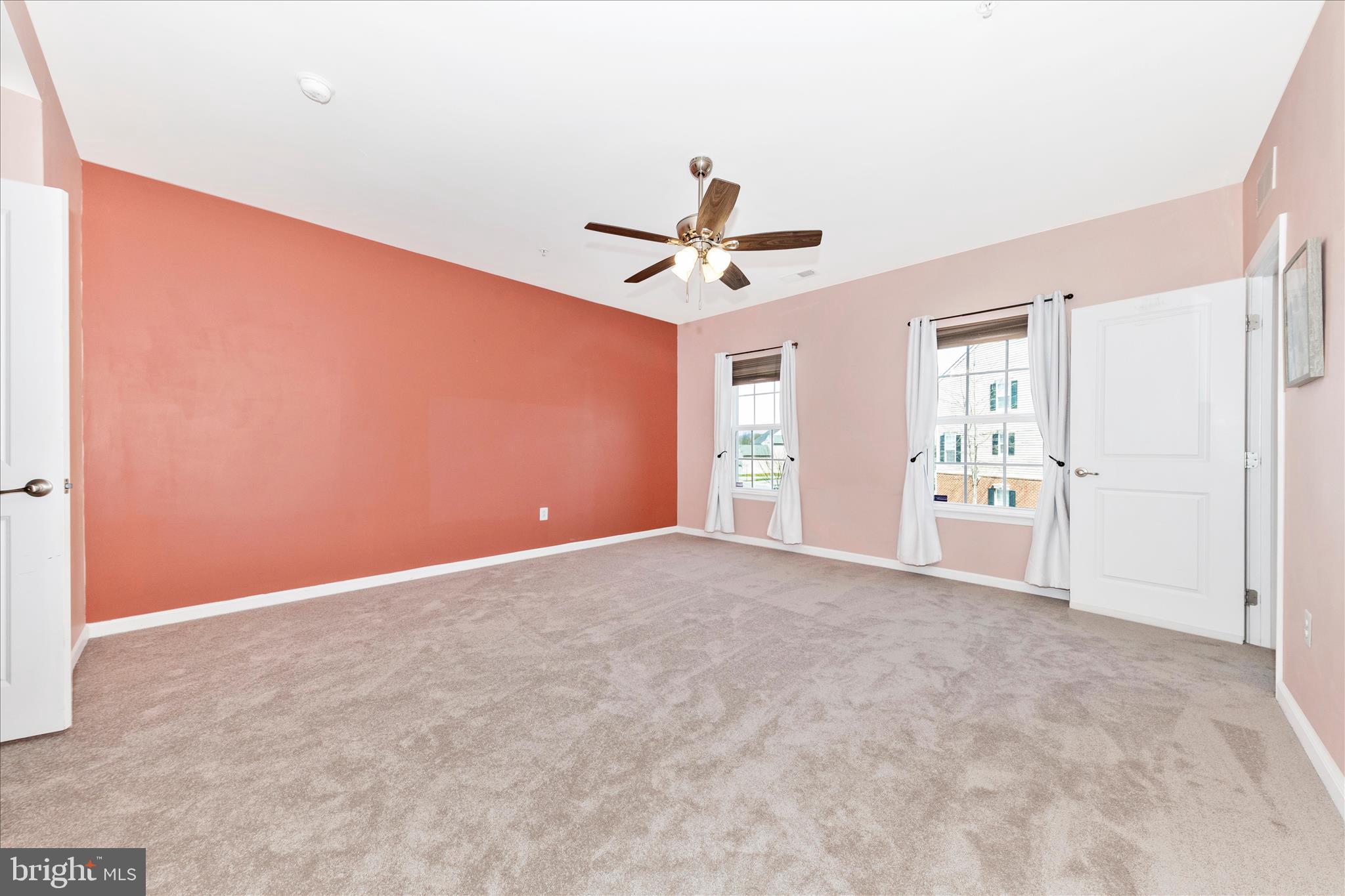 5043 Small Gains Way Frederick, MD 21703 - Photo 13 of 44 an empty room with windows and ceiling fan
