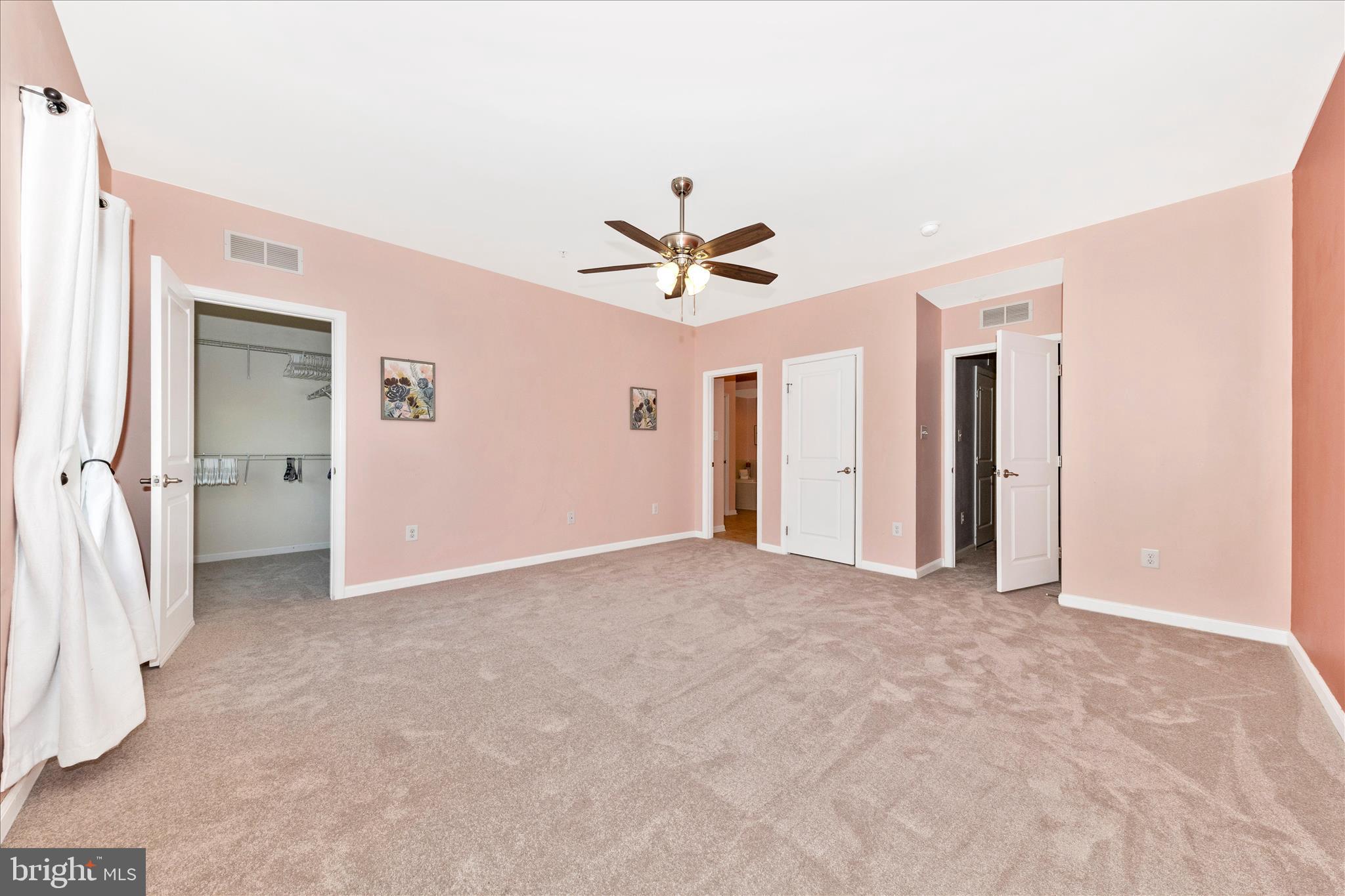 5043 Small Gains Way Frederick, MD 21703 - Photo 15 of 44 an empty room with closet and a ceiling fan