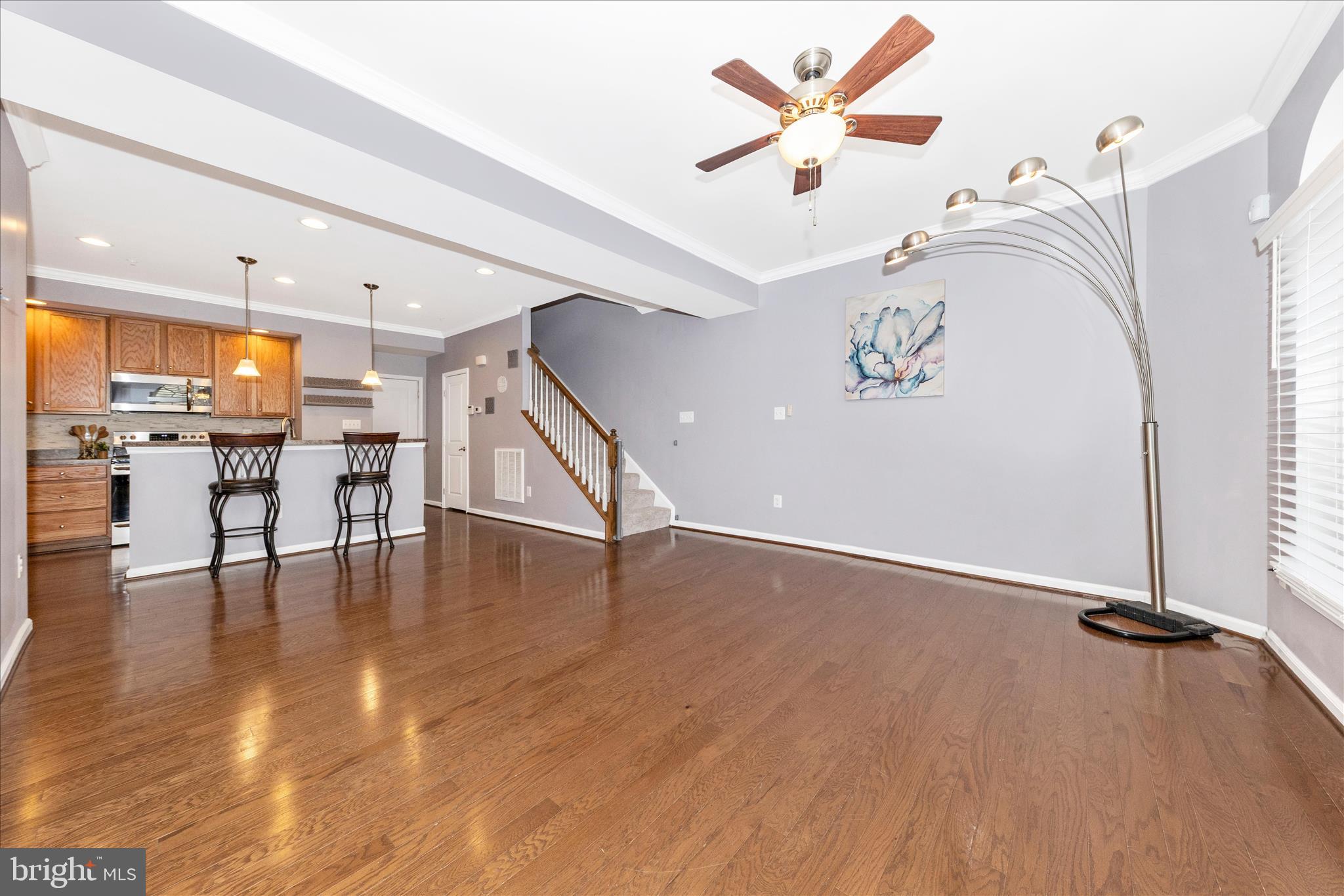 5043 Small Gains Way Frederick, MD 21703 - Photo 4 of 44 wooden floor in a room with a window and kitchen view