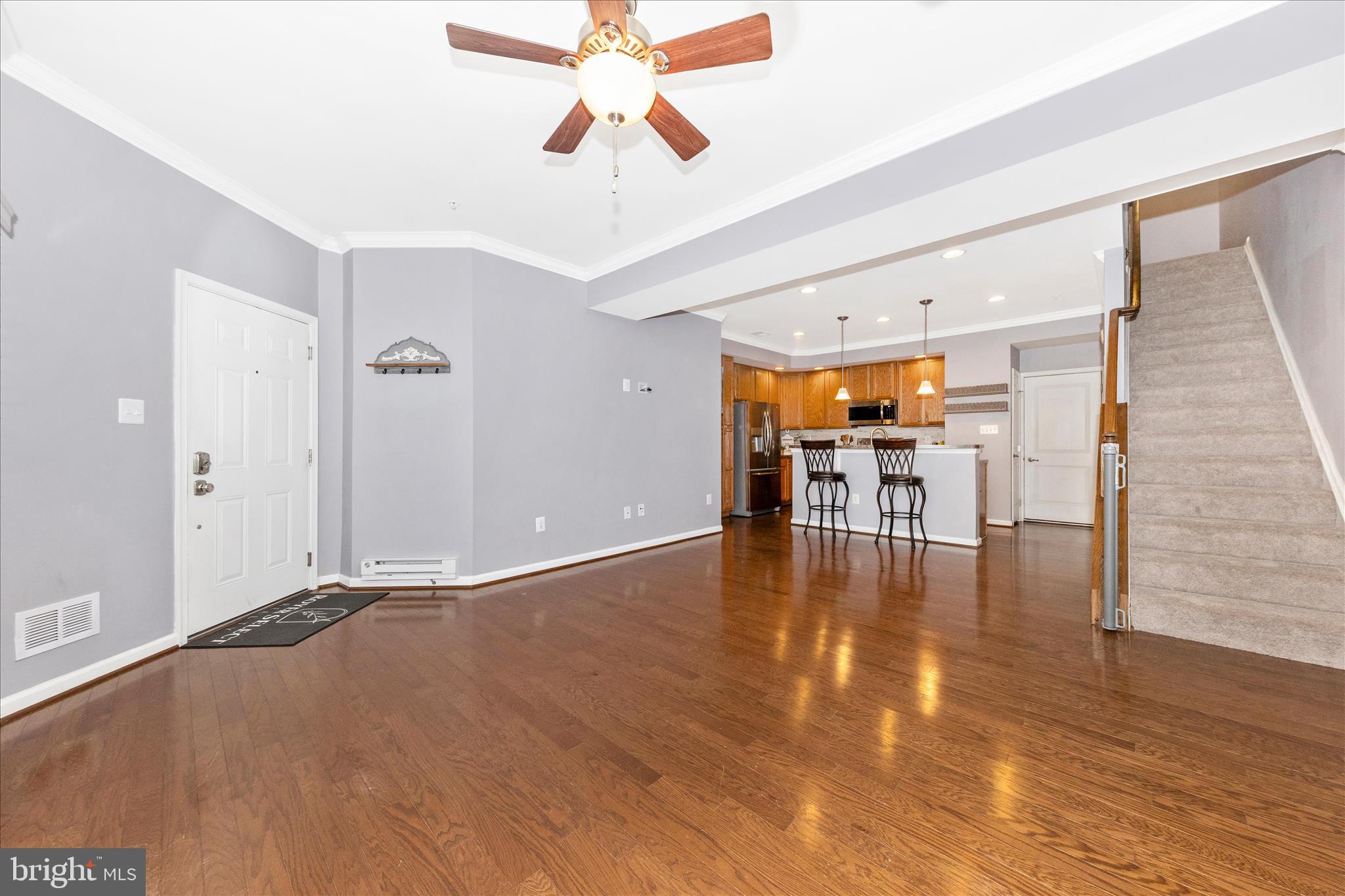 5043 Small Gains Way Frederick, MD 21703 - Photo 5 of 44 a view of a livingroom with furniture wooden floor window and a chandelier