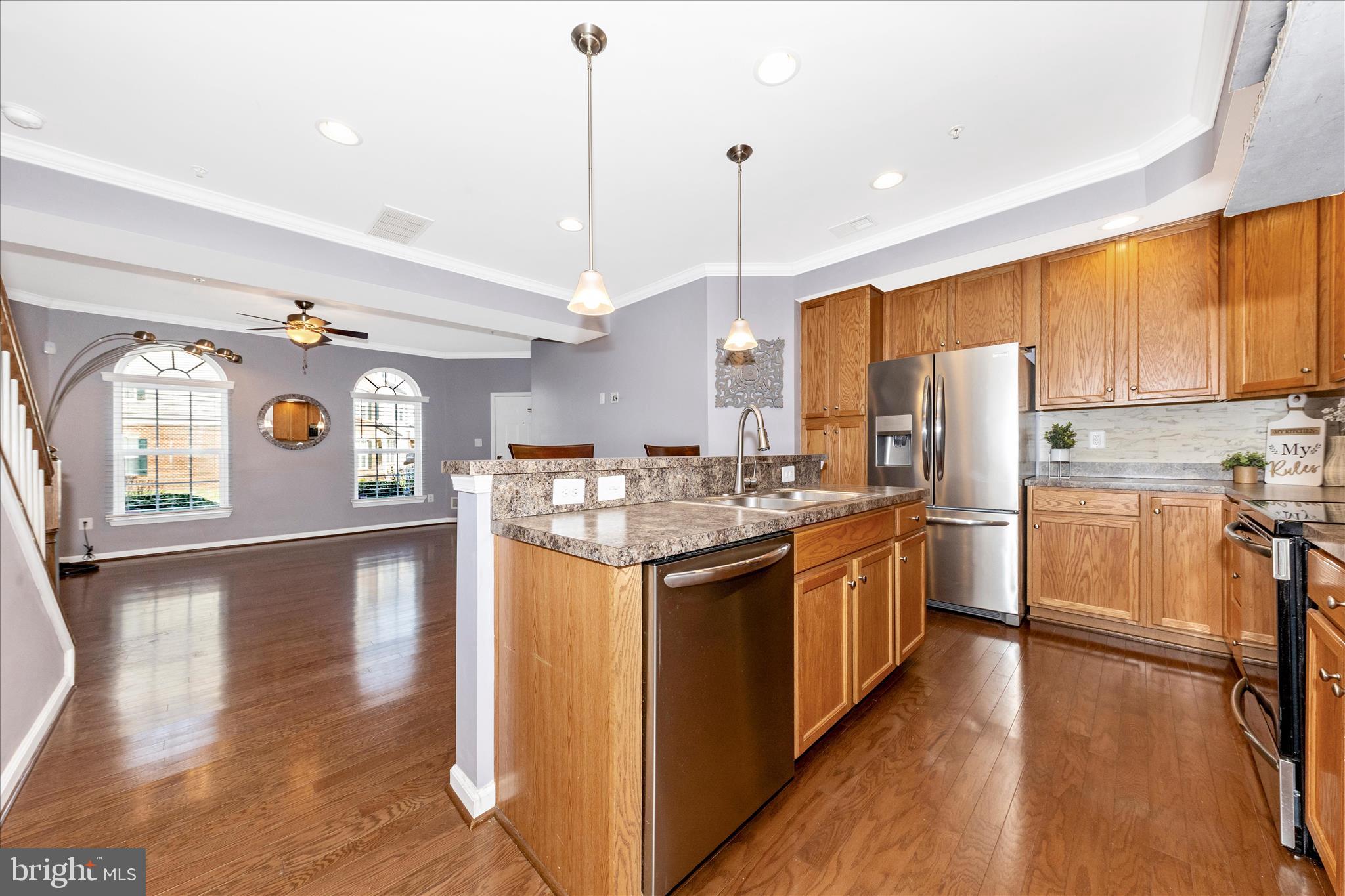 5043 Small Gains Way Frederick, MD 21703 - Photo 8 of 44 a kitchen with stainless steel appliances granite countertop a sink a stove and a refrigerator