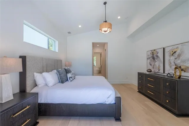 a bathroom with a granite countertop sink a mirror and a bathtub