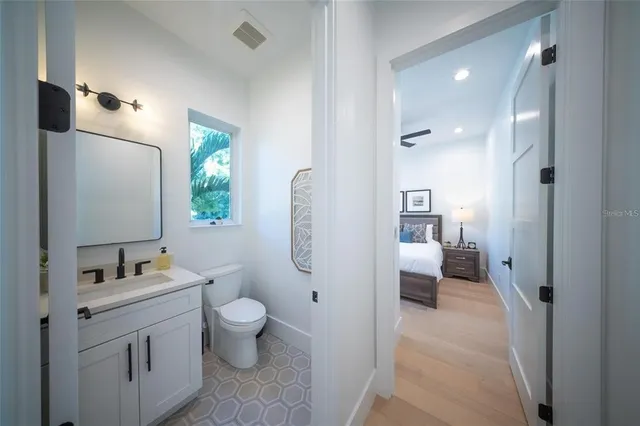 a en suite bathroom with a toilet sink and vanity