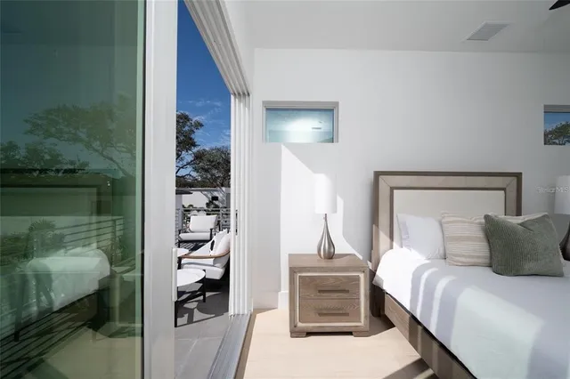 a bedroom with a bed and a large window