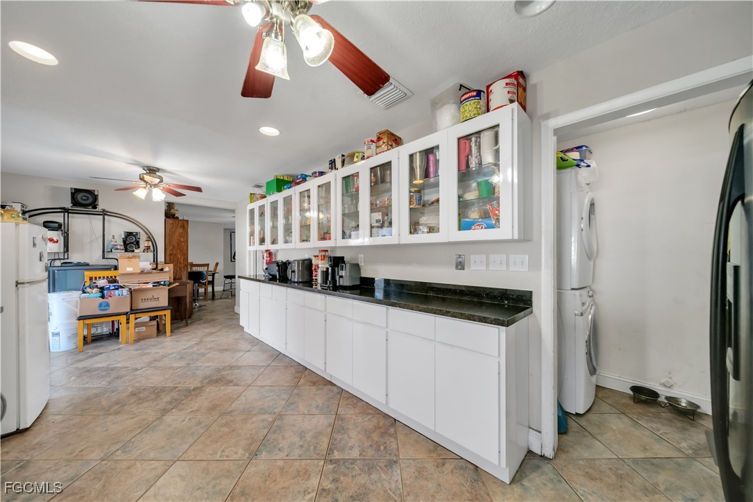 17255 Southwest 299th Street Homestead, FL 33030 - Photo 21 of 47 a kitchen with stainless steel appliances kitchen island granite countertop a refrigerator and a stove