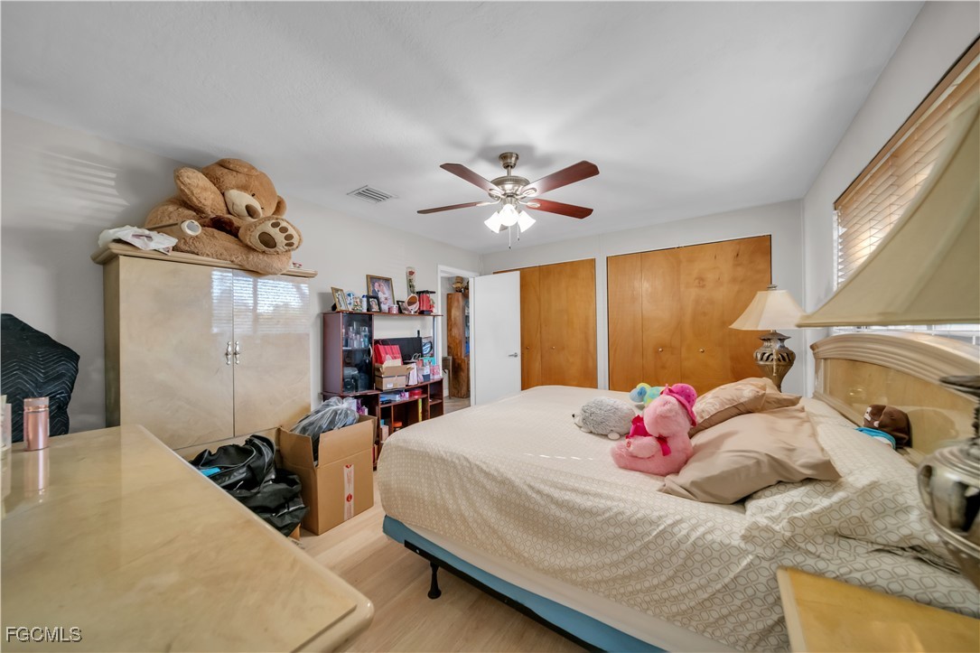 17255 Southwest 299th Street Homestead, FL 33030 - Photo 25 of 47 a bedroom with a bed and a chandelier