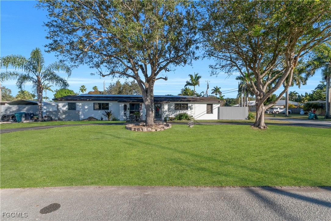 17255 Southwest 299th Street Homestead, FL 33030 - Photo 3 of 47 a front view of a house with a garden