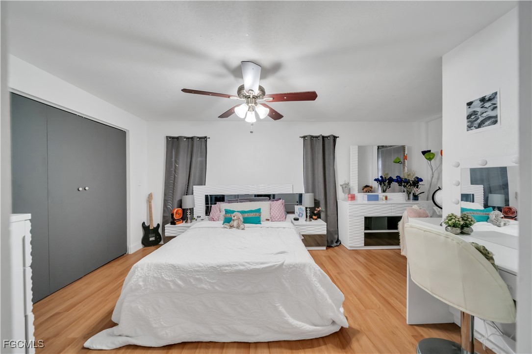 17255 Southwest 299th Street Homestead, FL 33030 - Photo 32 of 47 a bedroom with a bed and a chandelier