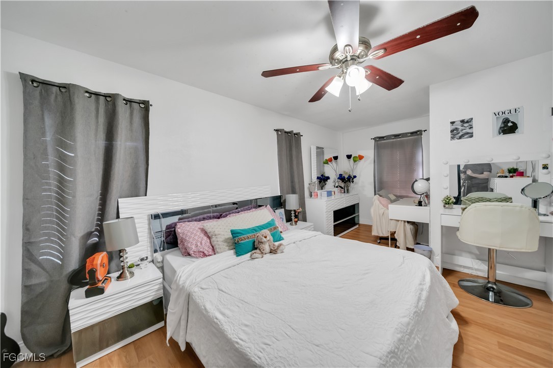 17255 Southwest 299th Street Homestead, FL 33030 - Photo 33 of 47 a bedroom with a bed and a chandelier