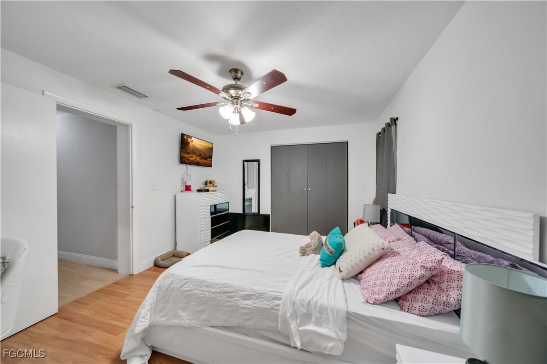 17255 Southwest 299th Street Homestead, FL 33030 - Photo 34 of 47 a bedroom with a large bed and a chandelier