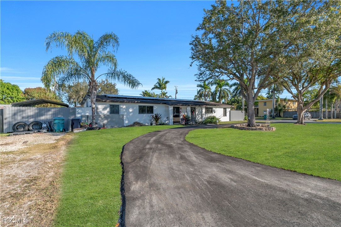 17255 Southwest 299th Street Homestead, FL 33030 - Photo 4 of 47 a front view of a house with garden
