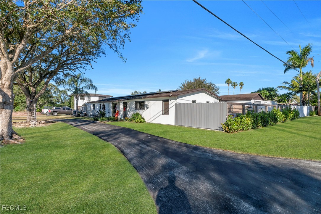 17255 Southwest 299th Street Homestead, FL 33030 - Photo 8 of 47 a front view of a house with a yard and trees