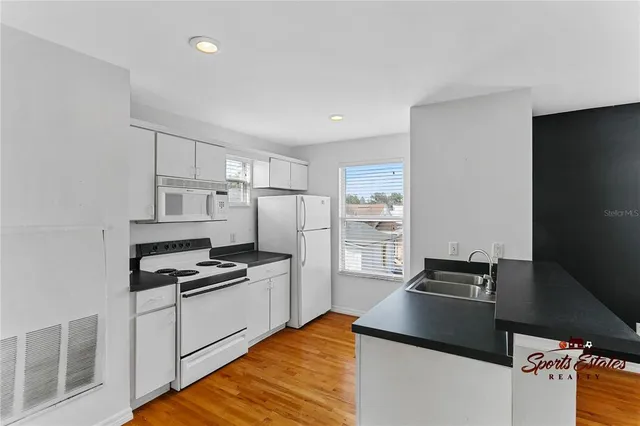 a kitchen with stainless steel appliances a refrigerator stove and microwave