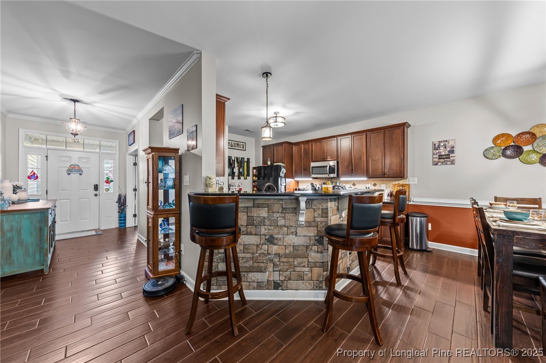 667 St Johns Loop Raeford, NC 28376 - Photo 14 of 50 a kitchen with stainless steel appliances kitchen island granite countertop a dining table chairs and a refrigerator