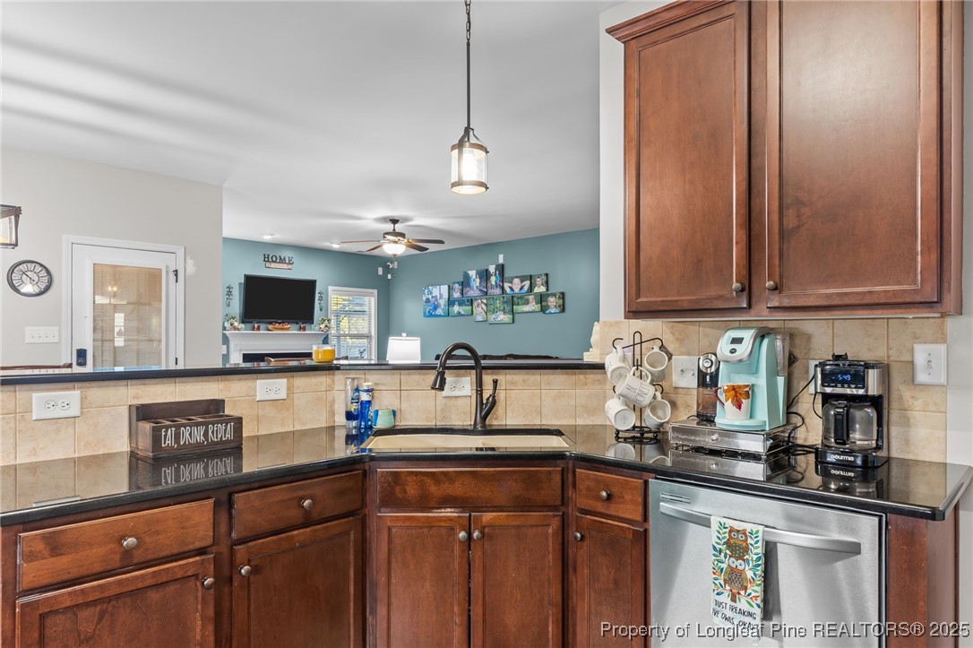 667 St Johns Loop Raeford, NC 28376 - Photo 17 of 50 a kitchen with stainless steel appliances granite countertop a sink and a microwave