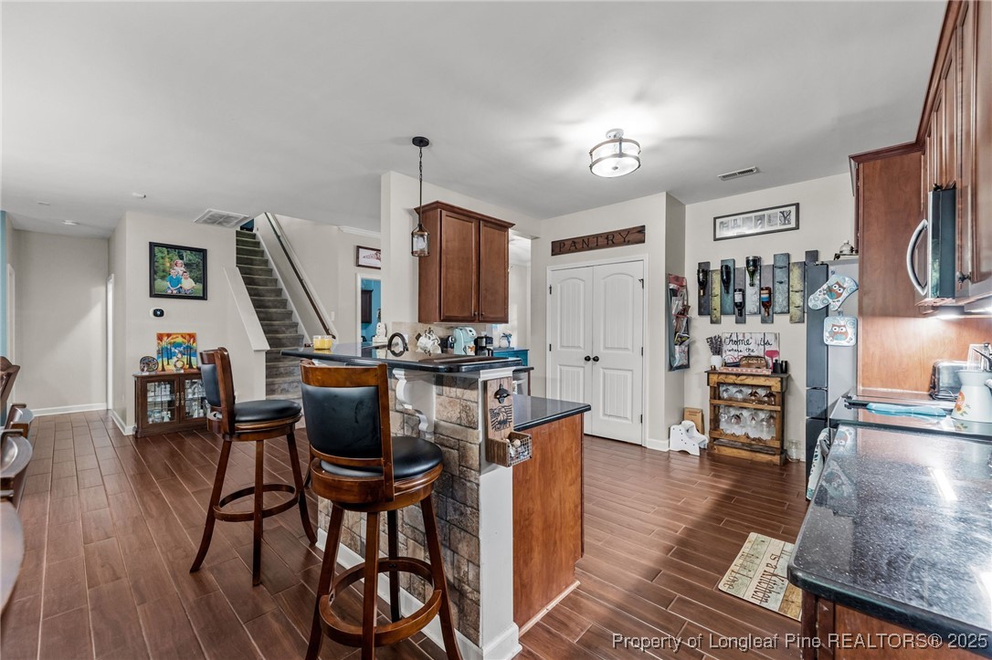 667 St Johns Loop Raeford, NC 28376 - Photo 18 of 50 a view of a dining room with furniture and wooden floor
