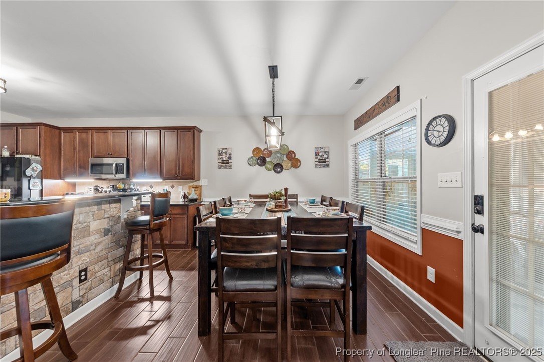 667 St Johns Loop Raeford, NC 28376 - Photo 19 of 50 a view of a dining room with furniture window and wooden floor