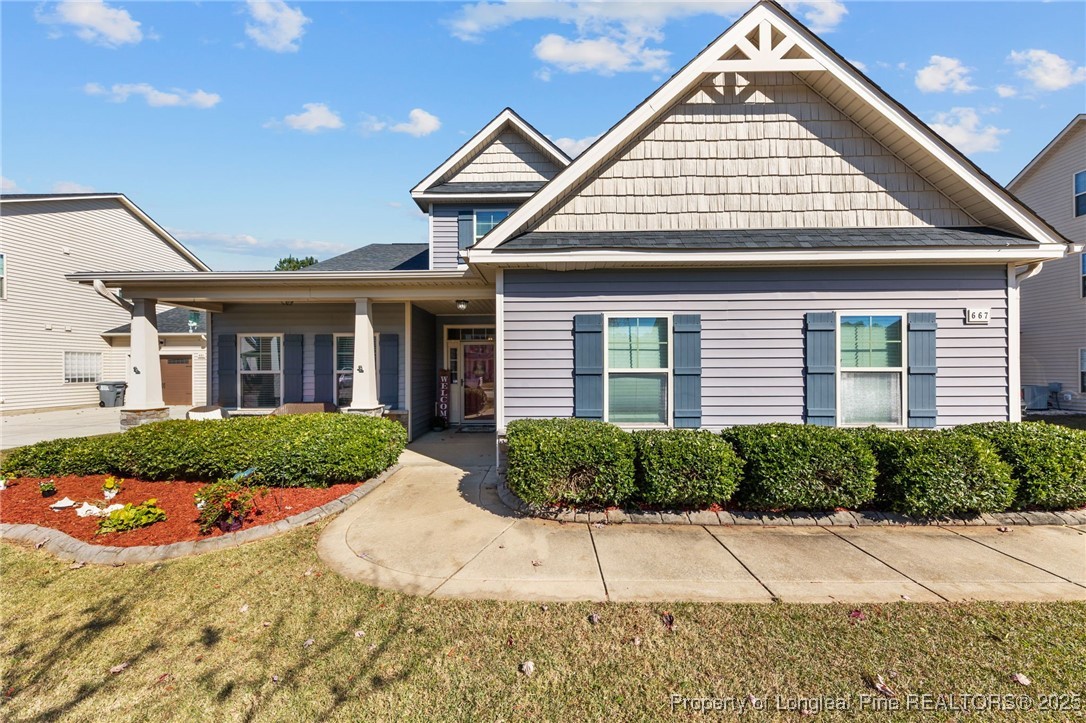 667 St Johns Loop Raeford, NC 28376 - Photo 2 of 50 a view of a brick house with a yard