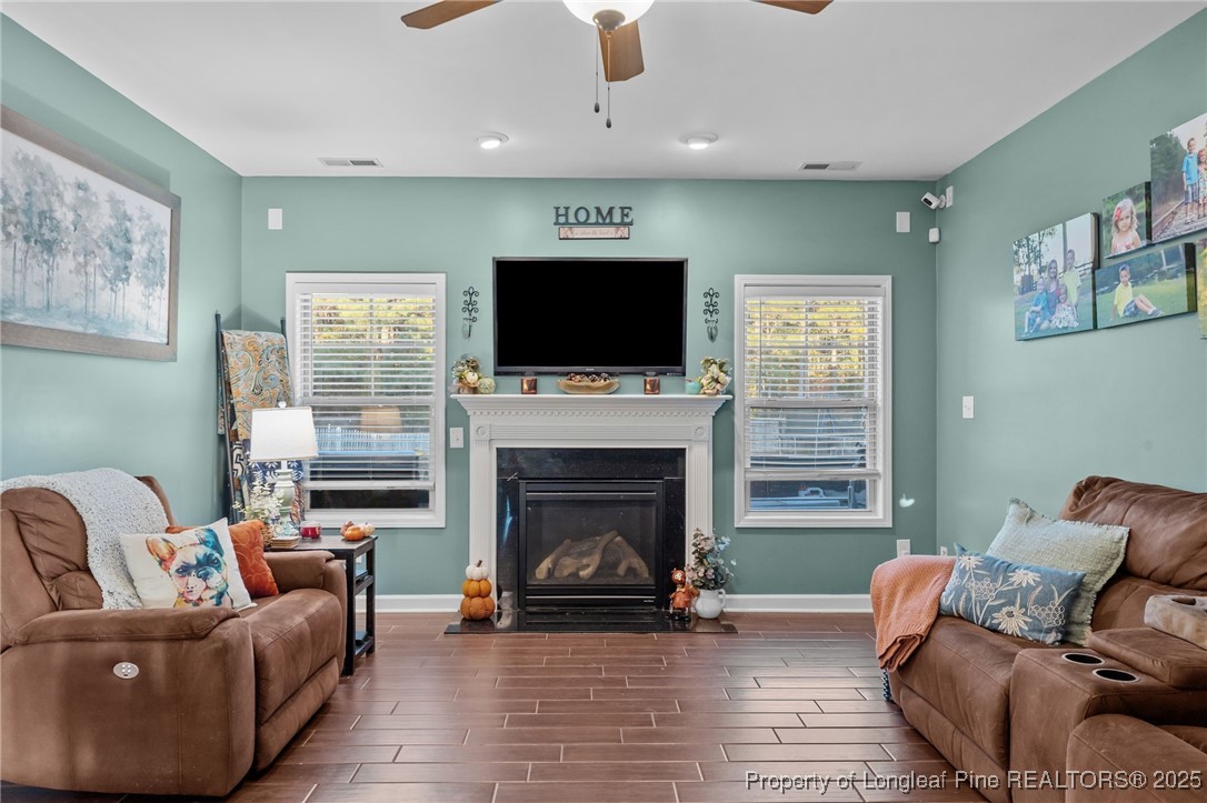 667 St Johns Loop Raeford, NC 28376 - Photo 23 of 50 a living room with furniture a flat screen tv and a fireplace