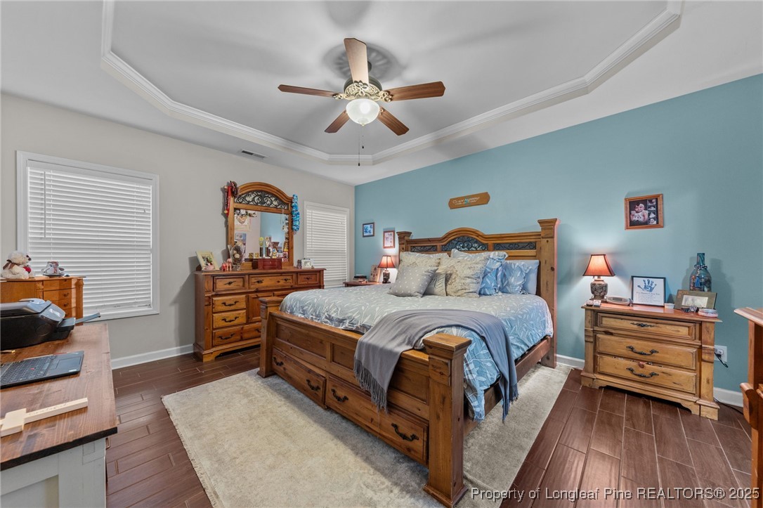 667 St Johns Loop Raeford, NC 28376 - Photo 24 of 50 a bedroom with a bed and a chandelier