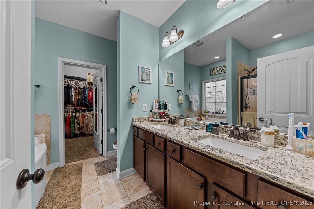 667 St Johns Loop Raeford, NC 28376 - Photo 26 of 50 a bathroom with a sink double vanity and a mirror