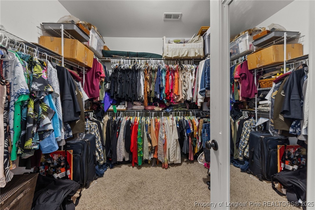 667 St Johns Loop Raeford, NC 28376 - Photo 29 of 50 a view of walk in closet with clothes