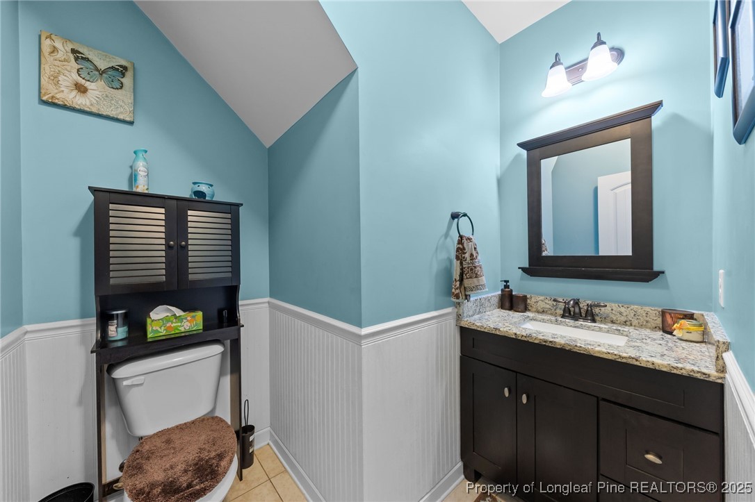 667 St Johns Loop Raeford, NC 28376 - Photo 32 of 50 a bathroom with a sink vanity and a mirror