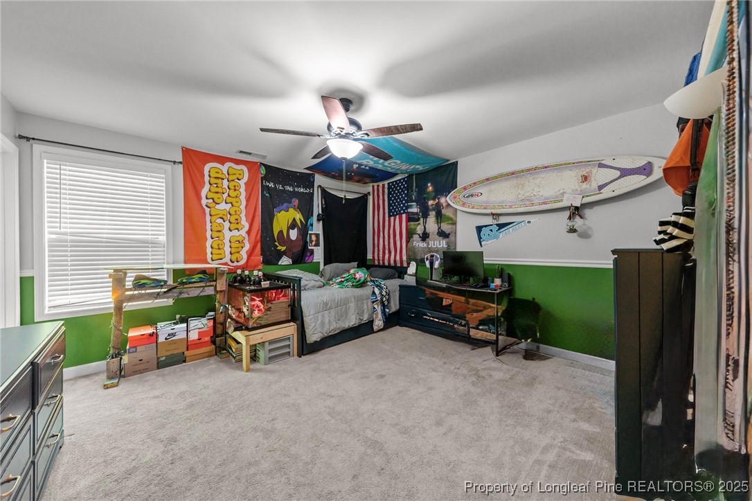 667 St Johns Loop Raeford, NC 28376 - Photo 36 of 50 a living room with furniture a window and a flat screen tv