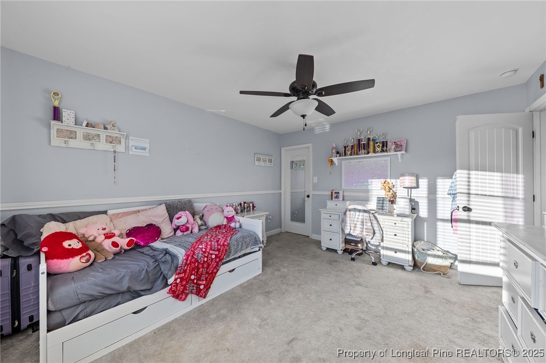 667 St Johns Loop Raeford, NC 28376 - Photo 38 of 50 a bedroom with furniture and a chandelier
