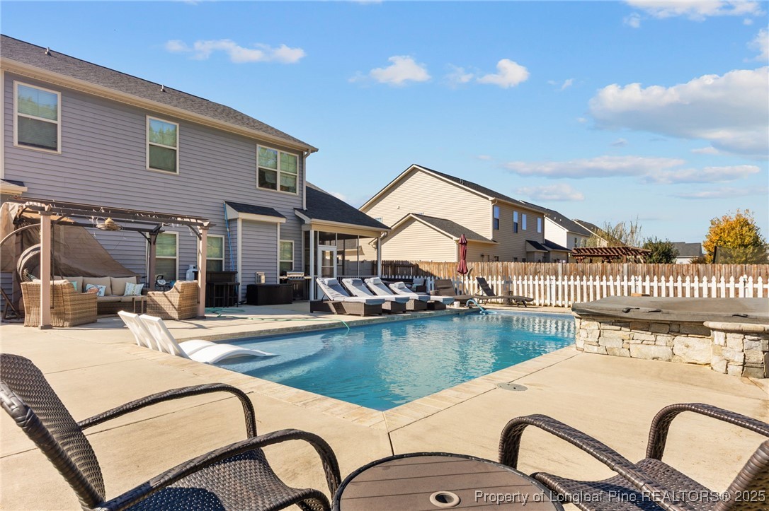 667 St Johns Loop Raeford, NC 28376 - Photo 45 of 50 a swimming pool with outdoor seating and yard