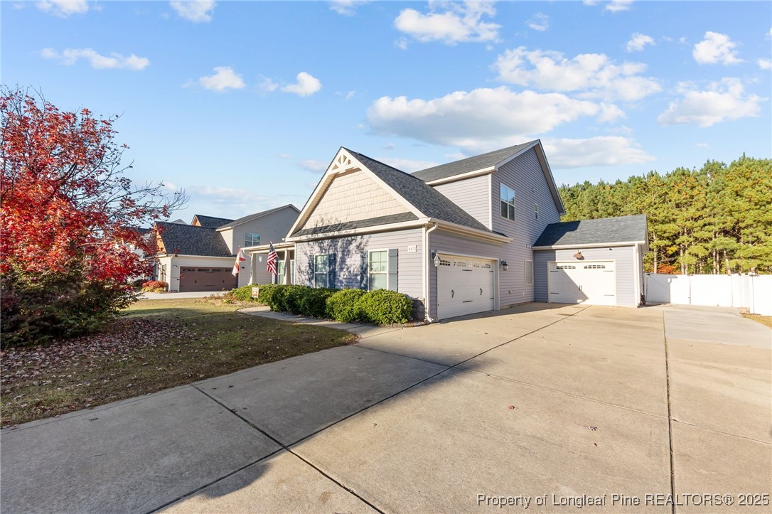 667 St Johns Loop Raeford, NC 28376 - Photo 9 of 50 a front view of a house with a yard and garage