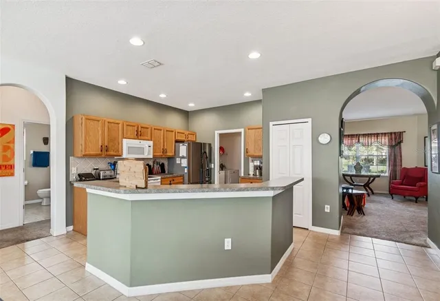 a living room with furniture a flat screen tv and a large window