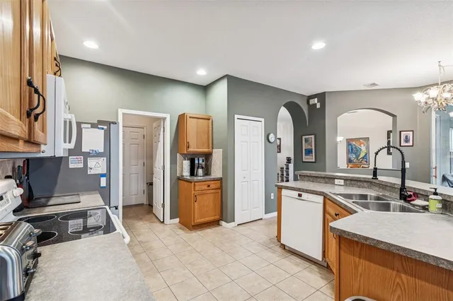 a living room with furniture a flat screen tv and a floor to ceiling window