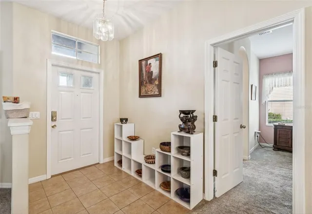 a dining room with furniture a chandelier and a rug