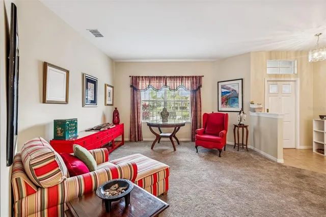 a living room with furniture and painting on the wall