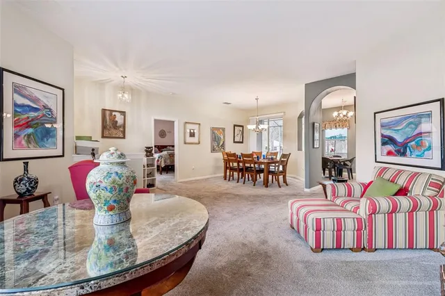 a view of a dining room with furniture large windows and wooden floor