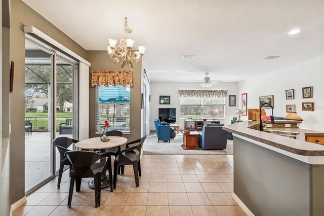 a view of a dining room with furniture and a chandelier