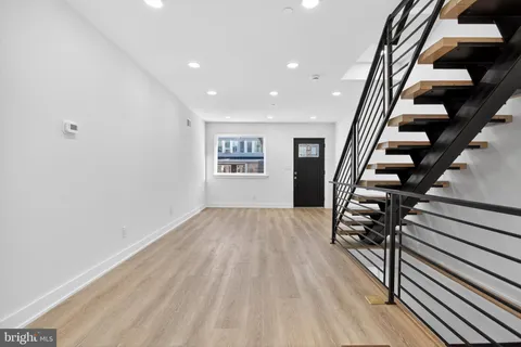 wooden floor in an empty room with stairs
