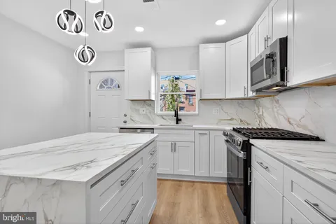 a kitchen with cabinets appliances and a counter top