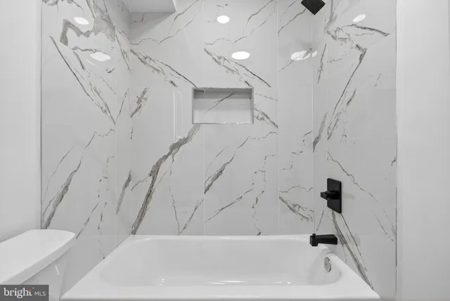 a bathroom with a bathtub and a toilet