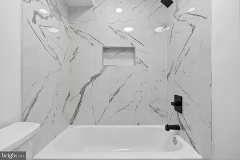 a bathroom with a bathtub and a toilet