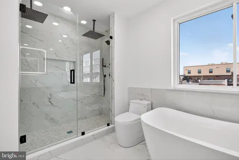 a bathroom with a bathtub and a shower