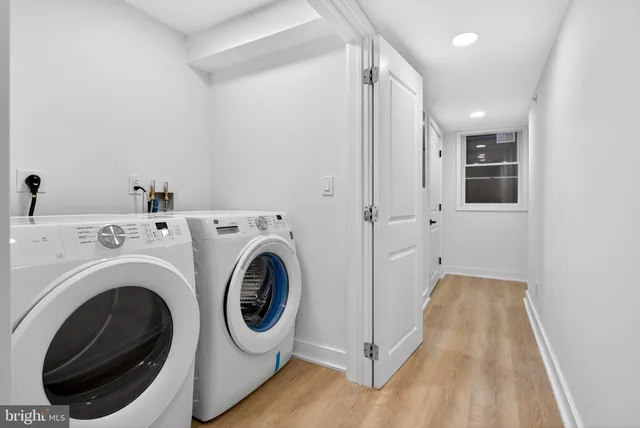a view of a hallway with washer and dryer