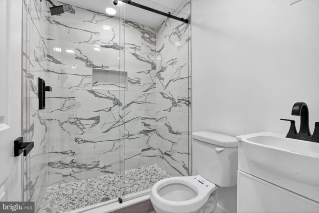 a bathroom with a toilet and shower