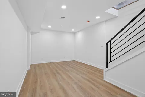 a view of an empty room with wooden floor