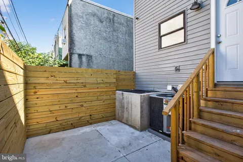 a view of a house with wooden fence